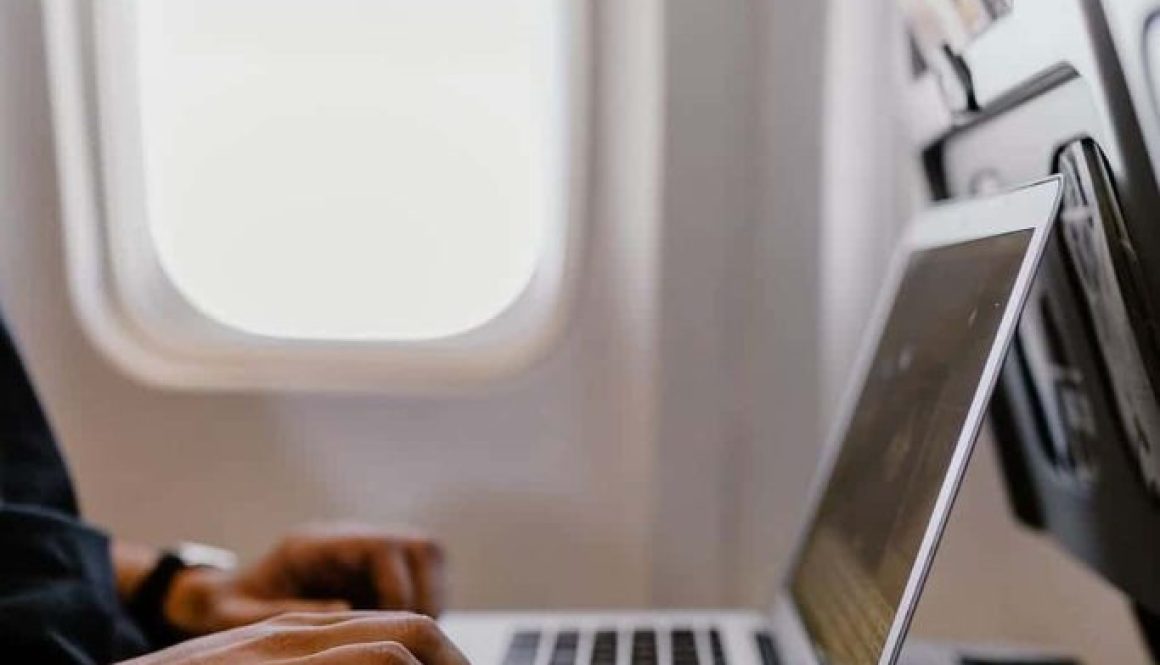 Uomo utilizzando un laptop in aereo